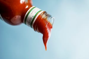 Ketchup flowing out of bottle